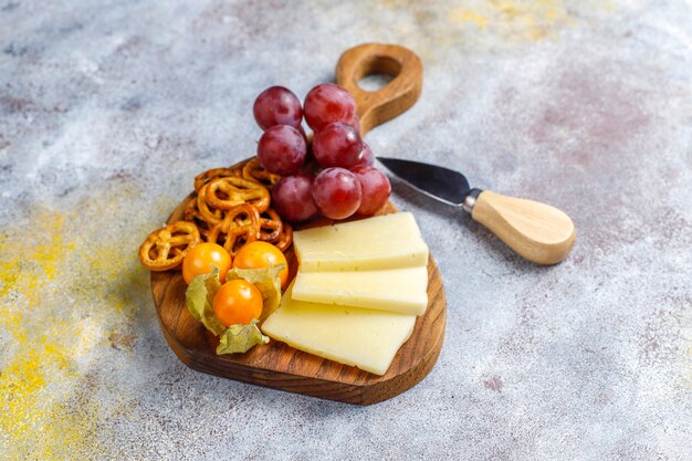 Cheese plate with delicious tilsiter cheese and snacks.