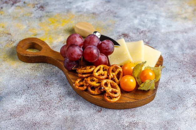 Cheese plate with delicious tilsiter cheese and snacks.