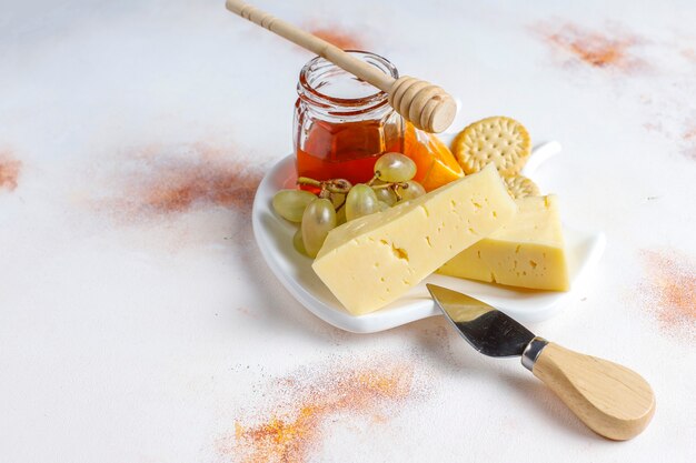 Cheese plate with delicious tilsiter cheese and snacks.