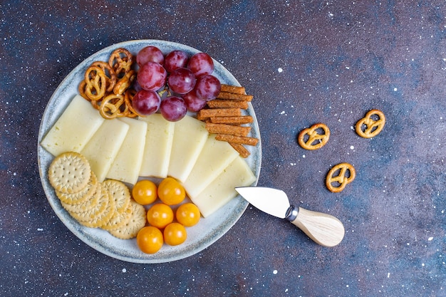 Cheese plate with delicious tilsiter cheese and snacks.