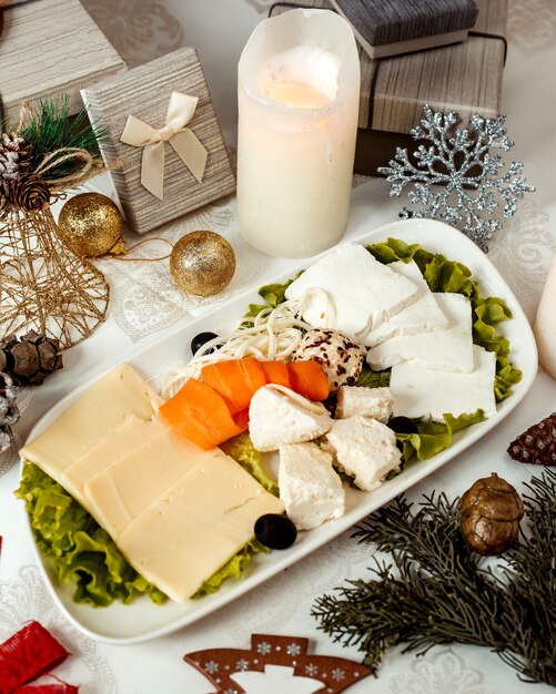 Cheese plate with sliced apricot and olives