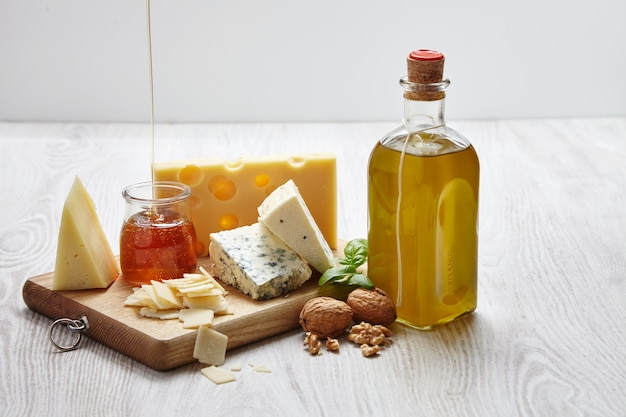 Cheese plate with vegetables and supplies top view