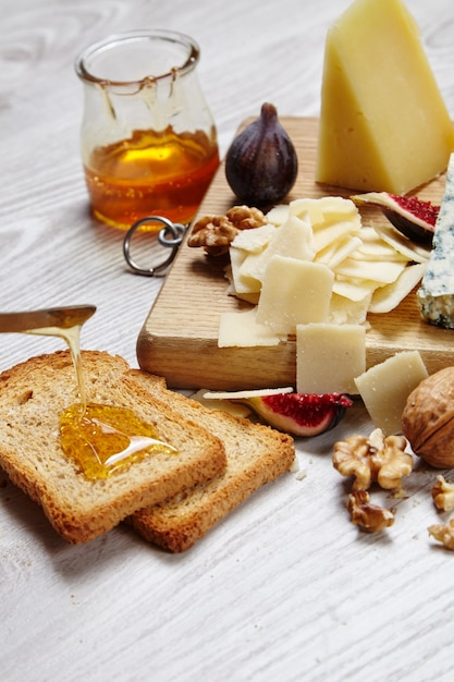 Cheese plate with vegetables and supplies top view