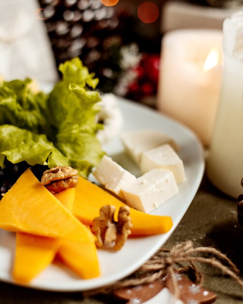 Cheese plate with walnuts and herbs