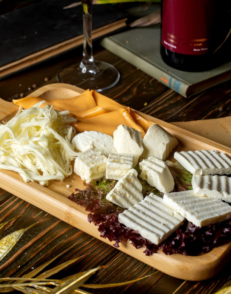 Free Photo cheese plate with white cheese string cheese and yellow cheese