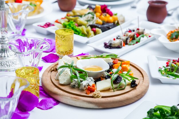 Cheese plate on wooden board side view