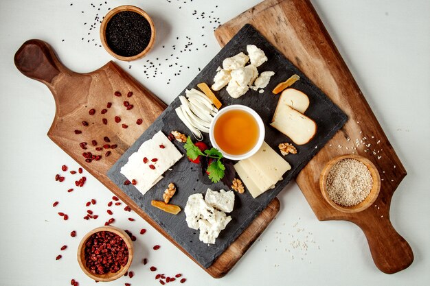 Cheese plate on wooden board top view