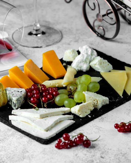 Cheese platter with cheddar blue goat and white cheese parmesan and grape