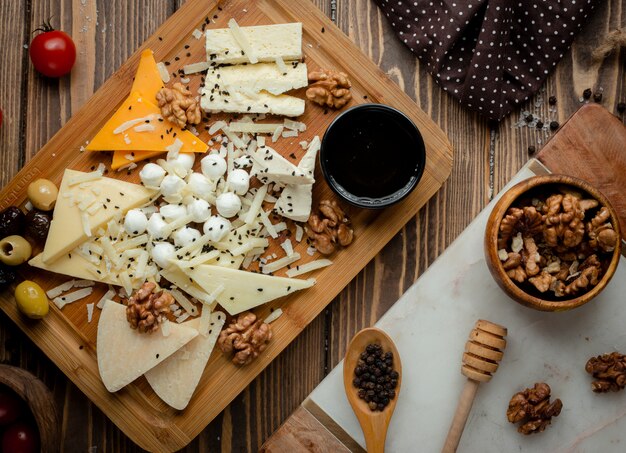 Cheese platter with olives and walnuts.