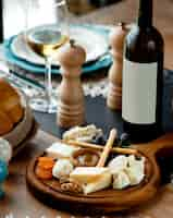 Free photo cheese set with red wine on wooden board