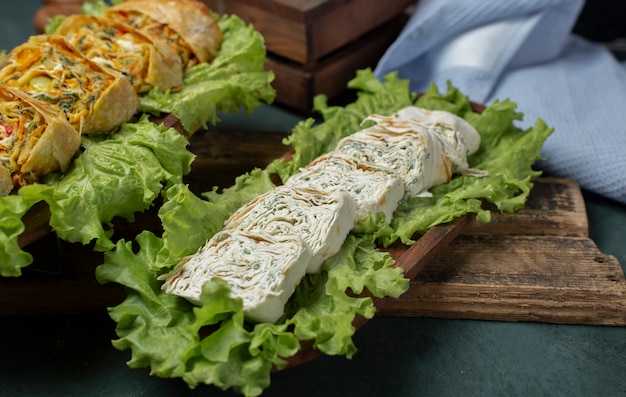 Cheese slices served on lettuce leaves