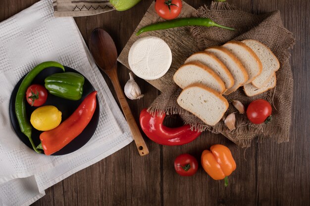 Cheese, vegetabels and bread. Top view