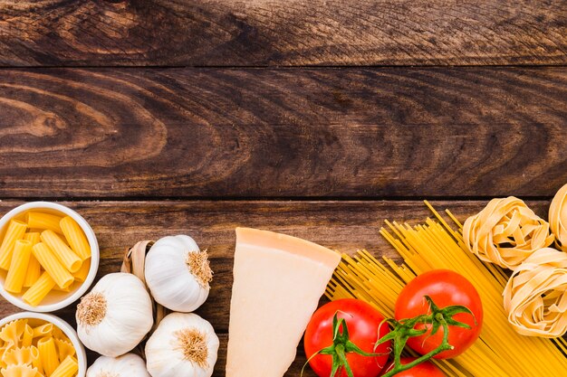 Cheese and vegetables near pasta