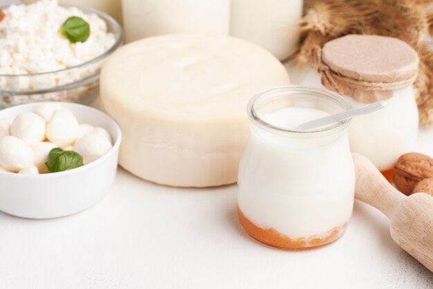 Cheese wheel and milk in jars