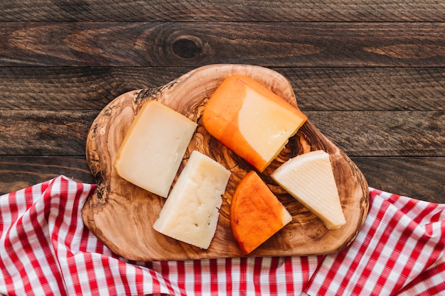 Cheese on wood near napkin