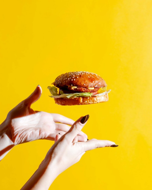 Cheeseburger with bun topped with sesame