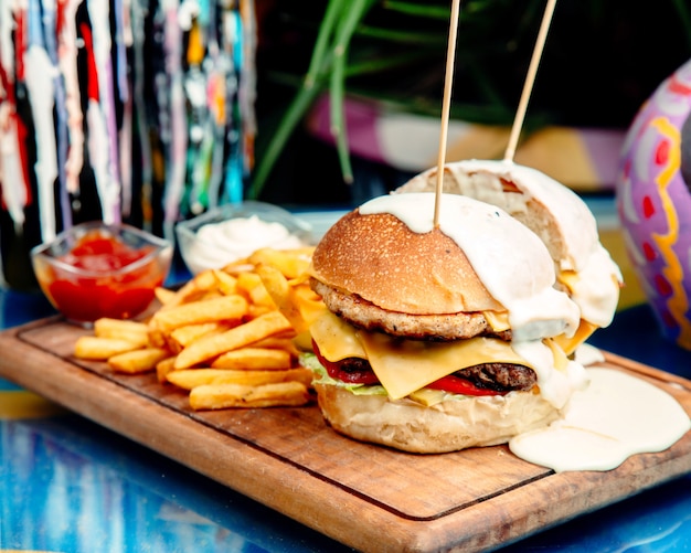 Cheeseburger with French Fries on the Table