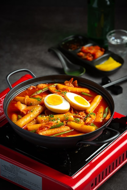 Free photo cheesy tokbokki korean traditional food on black board background. lunch dish.