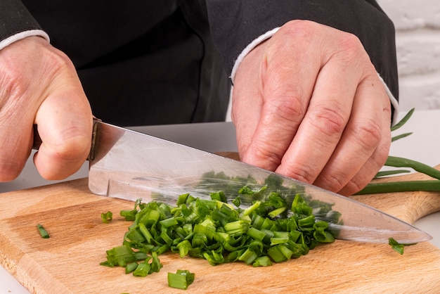 Free photo chef chopping chives with knife