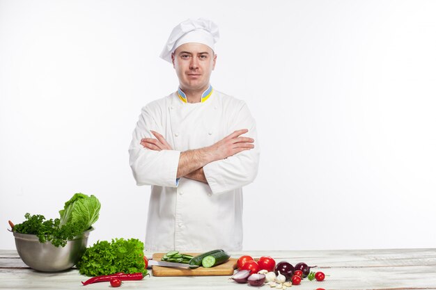 Chef cooking fresh vegetable salad in his kitchen