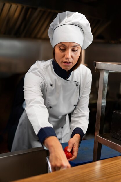 Chef cooking in the kitchen while wearing professional attire