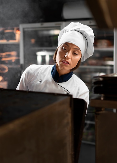 Chef cooking in the kitchen while wearing professional attire