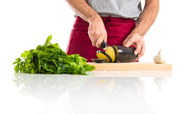 Chef cutting an aubergine