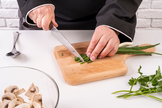 Chef cutting chives