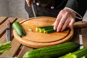 Free photo chef cutting cucumbers