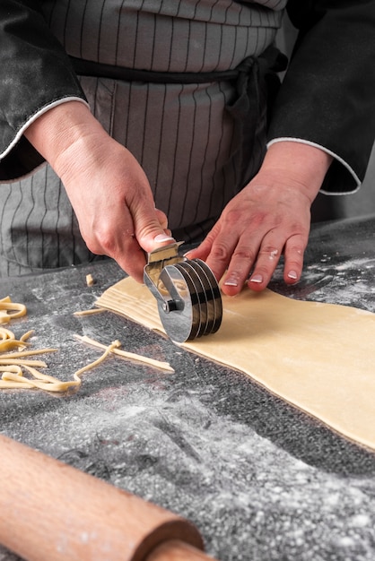 Chef cutting dough strips