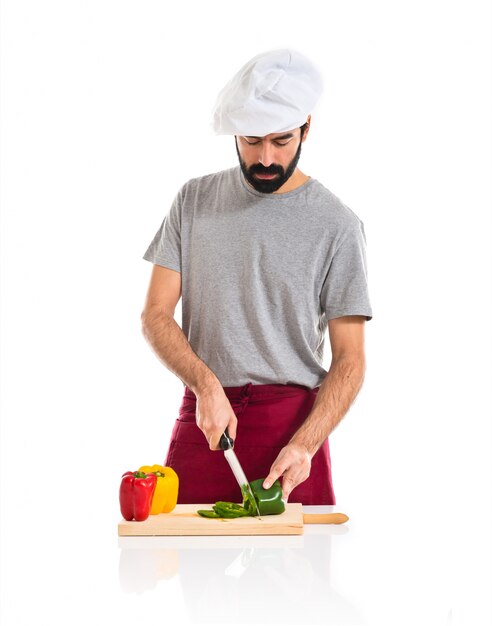 Chef cutting green pepper