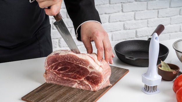 Chef cutting into big peace of meat