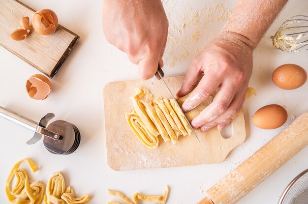 Chef cutting pasta dough