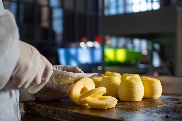 Chef cutting yellwo apples in the kitchen