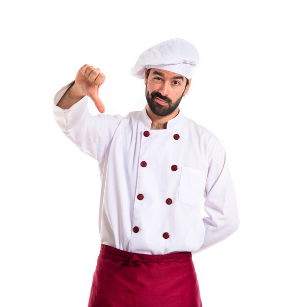 Chef doing a bad signal over white background