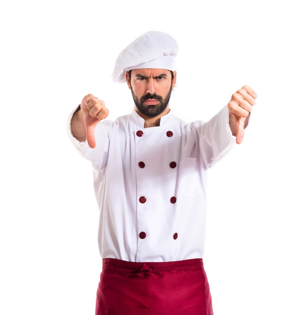 Chef doing a bad signal over white background