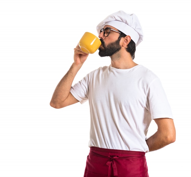 Chef drinking coffee over white background