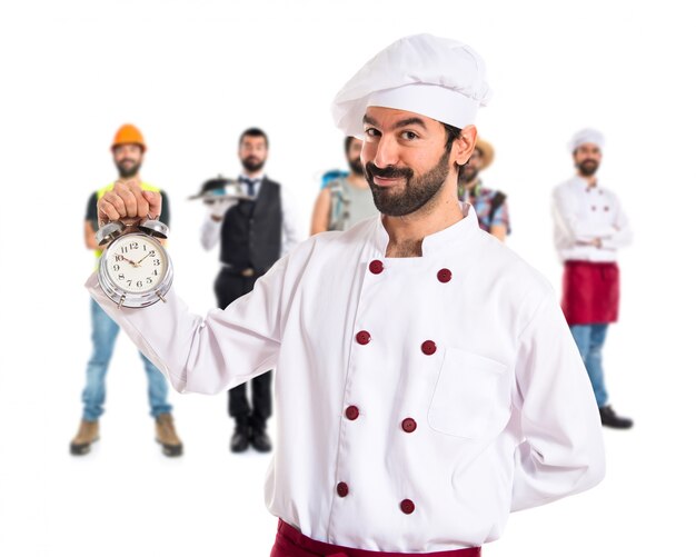 Chef holding a clock over white background