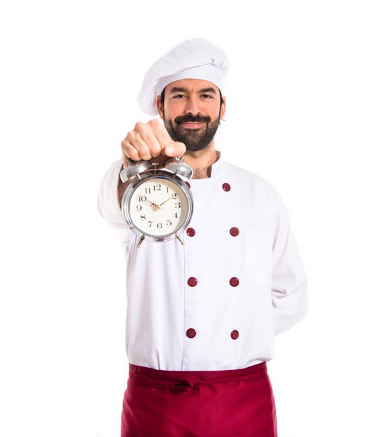 Chef holding a clock over white background