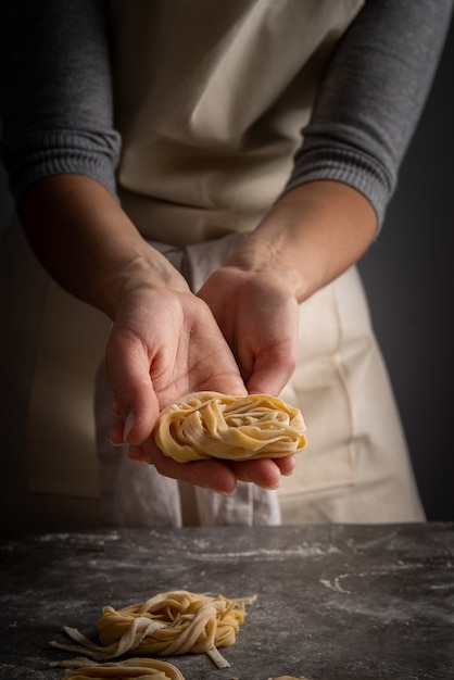 Chef holding fresh pasta
