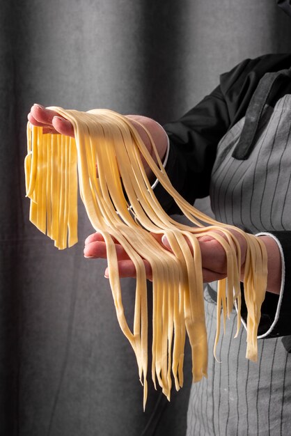 Chef holding fresh pasta