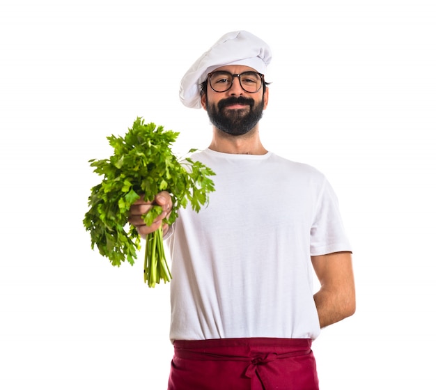 Chef holding lettuce over white background