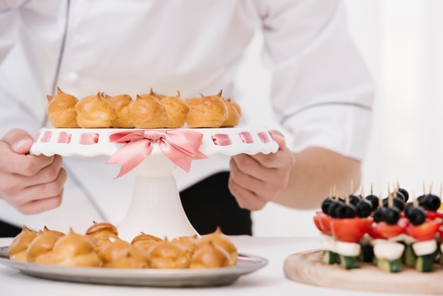 Chef holding plate with flamed meringue