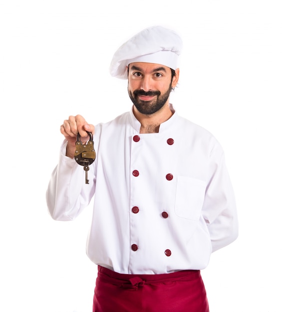 Chef holding vintage padlock over white background