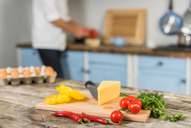 Chef in kitchen cooking with vegetables