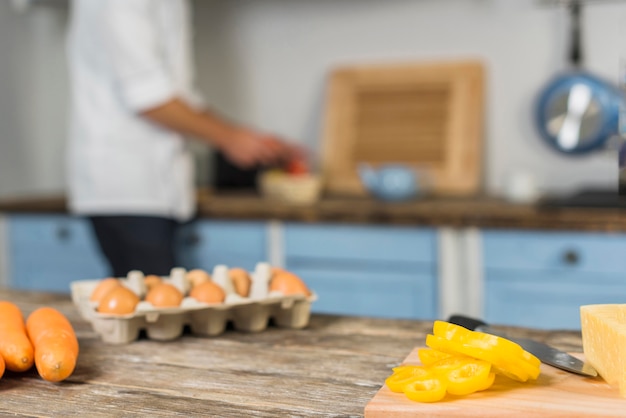 Chef in kitchen cooking with vegetables