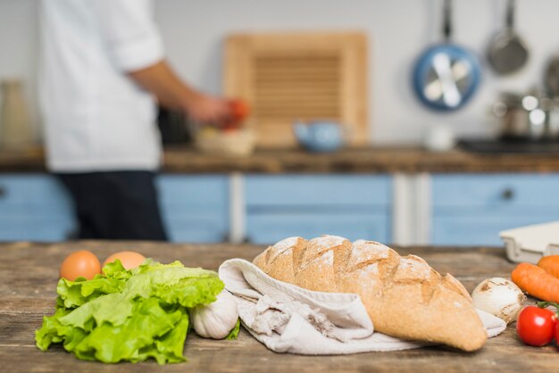 Chef in kitchen cooking with vegetables