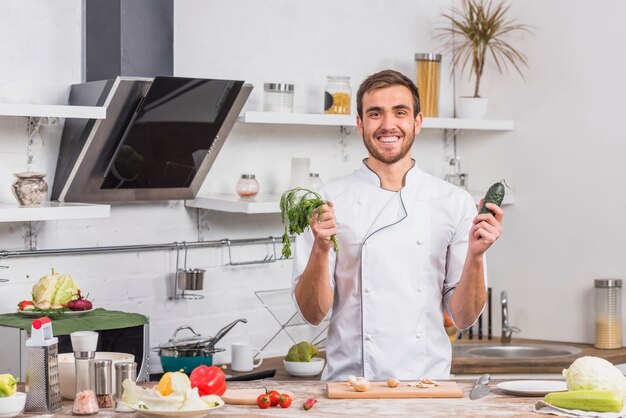 Chef in kitchen cooking with vegetables