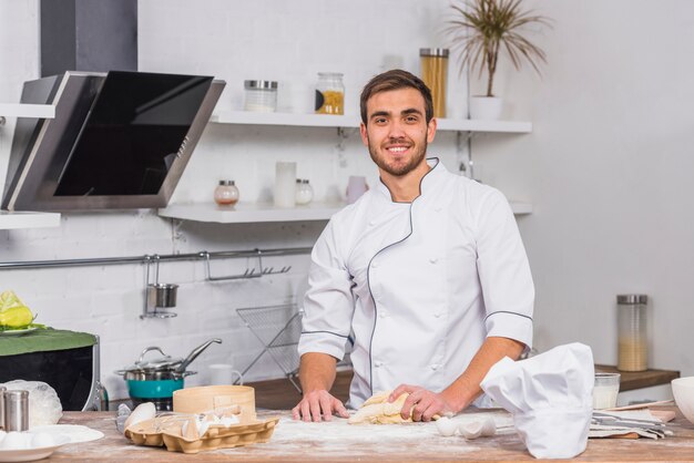 Chef in kitchen making dough