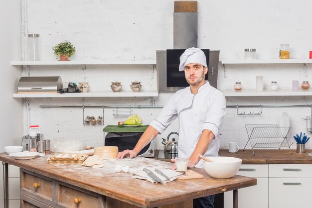 Chef in kitchen making dough